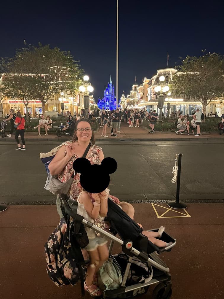 woman and girl with stroller in sidewalk of Main street Disney World